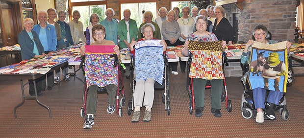 Volunteers at Wesley Homes Lea Hill display pillowcases they made for Mary Bridge Hospital.