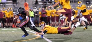 Auburn Mountainview's Nate Hardin tries to escape the grasp of Enumclaw's Peter Nordby.