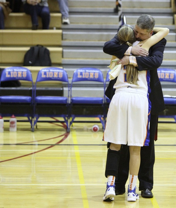 Auburn Mountainview girls basketball coach Chris Carr gets a hug from his star player
