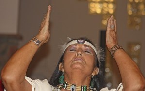 Pat Walker of Firestarters Ministries prays while performing an interpretive dance during the Arise