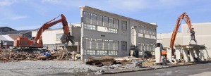 Crews begin to demolish the remaining walls of the storied