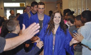 Auburn Mountainview High School graduating seniors walk through the Arthur Jacobsen Elementary halls and high-five the kids.