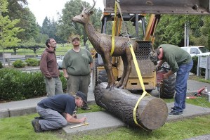 Workers including sculptor Brad Rude