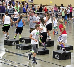 NBC Camp director Roger Smith coaches girls through drills at the camp’s Intensity Night on Tuesday at Auburn Adventist Academy. About 1