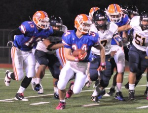 Auburn Mountainview senior Cramer Helton finds a seem during the opening kickoff against Decatur.
