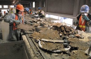 Workers sort construction debris at Glacier Recycle