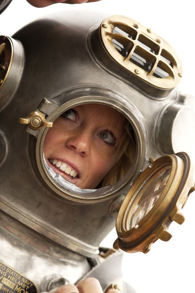 Auburn's Cindy Ross tries on a 1947 Mark V helmet and diving suit for size. Dressed in 190 pounds of equipment