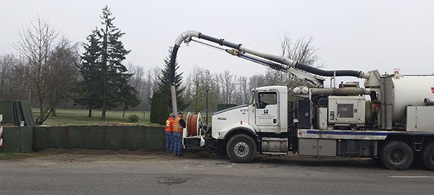 Crews were busy removing temporary flood protection barriers along Pacific Park on Tuesday. The barriers
