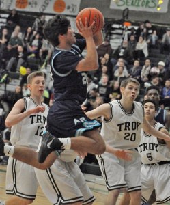 The Ravens' Austin Kirby drives for two against the Trojans' defense during SPSL 3A play Friday night.
