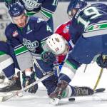 The Thunderbirds&rsquo; Turner Ottenbreit, left, and Donovan Neuls sandwich the Oilers&rsquo; Tyson Gruninger in a scramble for the puck Tuesday night at the ShoWare Center. COURTESY PHOTO, Brian Liesse, T-Birds