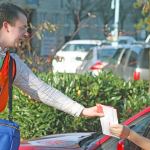 Ryan Mann of King Country Elections collects a mail-in ballot from a driver in front of the Regional Justice Center on Tuesday afternoon. MARK KLAAS, Kent Reporter