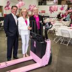Michael Engle, left, board chair of HERS Breast Cancer Foundation, Vera Packard, middle, executive director of the foundation, and Steve Raymond, president of Raymond Handling Concepts Corp., display the Pink Pallet Jack Pro at an open house event in Fremont, Calif. COURTESY PHOTO