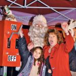 Mayor Nancy Backus, Stefany Sanchez and Santa help turn the switch on to light up the Christmas tree in the City Hall Plaza last year. RACHEL CIAMPI, Auburn Reporter