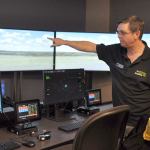 Jerry Wolfe, aviation faculty member and bachelor&rsquo;s degree program director at Green River College, points out features of an air traffic control tower simulator at the college&rsquo;s new Auburn Center. HEIDI SANDERS, Reporter