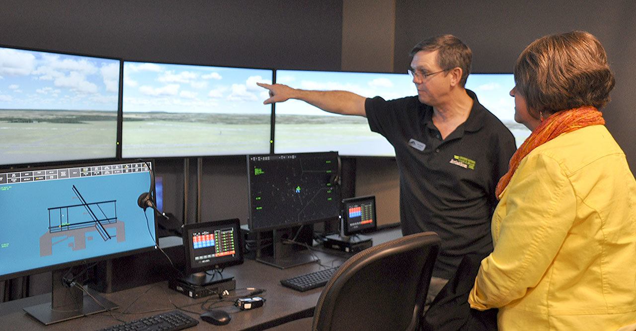 Jerry Wolfe, aviation faculty member and bachelor&rsquo;s degree program director at Green River College, points out features of an air traffic control tower simulator at the college&rsquo;s new Auburn Center. HEIDI SANDERS, Reporter
