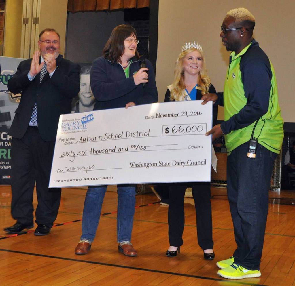 Cascade Principal Isaiah Johnson receives the $66,000 Fuel Up to Play 60 check from Leann Krainick (dairy farmer) with Alicia Smaciarz (state dairy ambassador) and Auburn Superintendent Alan Spicciati. RACHEL CIAMPI, Auburn Reporter