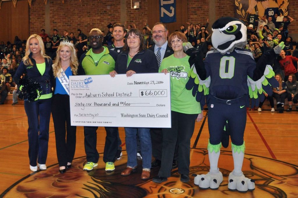 From left: SeaGal Melody, Alicia Smaciarz, Cascade Principal Isaiah Johnson, Seahawk Steven Hauschka, Leann Krainick, Auburn Superintendent Alan Spicciati, Carol Barker, and Blitz, with the check. RACHEL CIAMPI, Auburn Reporter