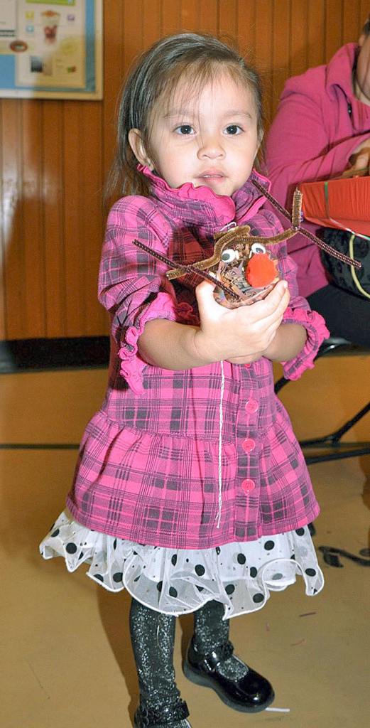 Aulani Angeles, 2, shows the reindeer ornament she made. RACHEL CIAMPI, Reporter