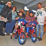Manager George Hall have Alfredo Susano-Vargas, 5, and Heiser Martinez-Vargas, 10, choose bikes. RACHEL CIAMPI, Reporter