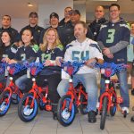 From right, on Spider-Man bikes: Marshall Willard, Manager George Hall, Leia Duckworth, Tammy Takayesu, and Andrea Hanson with her son Xander, 6. From right middle: Mike Carter (blue shirt), Arin Gardner (No. 3 Seahawks shirt) and in back, Coyote Carter (light blue shirt). Joining them are VRFA firefighters. RACHEL CIAMPI, Reporter