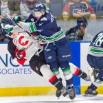 Thunderbirds defenseman Turner Ottenbreit delivers a hard check on a Prince George play during WHL play Friday night. COURTESY PHOTO, Brian Liesse, T-Birds
