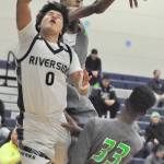 Auburn Riverside&rsquo;s Austin Kirby loses the ball on the dribble-drive to the basket as Todd Beamer&rsquo;s Richie Frazier attempts to block the shot. RACHEL CIAMPI, Auburn Reporter