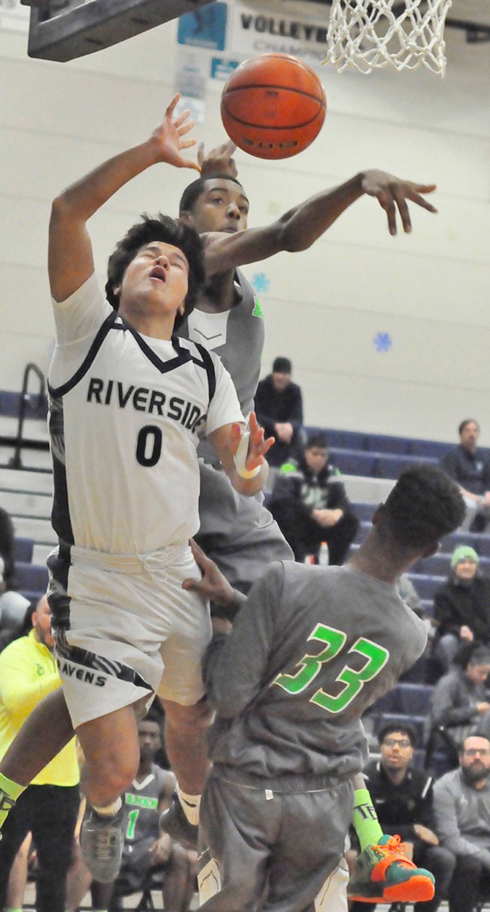 Auburn Riverside&rsquo;s Austin Kirby loses the ball on the dribble-drive to the basket as Todd Beamer&rsquo;s Richie Frazier attempts to block the shot. RACHEL CIAMPI, Auburn Reporter