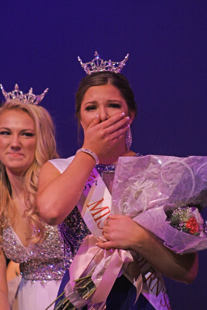 An emotional Elizabeth Enz, right, receives the crown from Jaclyn Seifert, 2016 Miss Auburn&rsquo;s Outstanding Teen. MARK KLAAS, Reporter