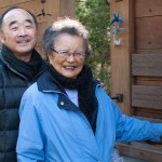 Kay Sakai points at her name on the Bainbridge Island Japanese American Exclusion Memorial, which includes the name of every Japanese American resident of the island removed under Civilian Exclusion Order No. 1. Behind her stands Clarence Moriwaki, founder of the Bainbridge Island Japanese American Exclusion Memorial. Photo by Enrique Pérez de la Rosa, WNPA Olympia News Bureau
