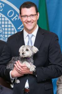 Sen. Joe Fain, R-Auburn, and his dog Waffles at a bill-signing event in 2015 for Fain-sponsored legislation to better protect animals against cruelty and abuse. COURTESY PHOTO