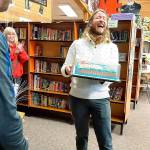 WGU Washington and Evergreen Heights staff surprised Richard Robertson on Monday with a cake, balloons and the news he had been chosen to receive a $10,000 scholarship from the Kent-based online university. COURTESY PHOTO, WGU Washington