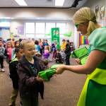 The Delta Dental of Washington Tooth Fairy hands out Smile Power lunch bags with the book, &ldquo;The Berenstain Bears Visit the Dentist&rdquo;, and a toothbrush inside to students at Arthur Jacobsen Elementary School. COURTESY, VanHouten Photography