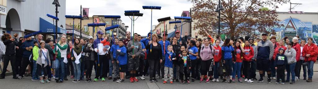 Volunteers, City and community leaders participate in the ceremonial Clean Sweep along Main Street and its sidewalks on Saturday morning. RACHEL CIAMPI, Auburn Reporter