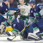 Seattle goalie Carl Stankowski covers the puck with trusty defenseman Ethan Bear next to him during WHL playoff action against the Silvertips on Saturday night in Everett. Stankowski made 20 saves on 23 shots to improve his playoff record to 6-0. COURTESY PHOTO, Brian Liesse, T-Birds