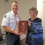 Kevin Olson, the Valley Regional Fire Authority deputy fire chief of technical services, presents volunteer Barbara Saelid with a plaque in honor of her 17 years of dedicated service to the legacy Auburn Fire Department and the VRFA. COURTESY PHOTO, VRFA