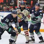 The Thunderbirds&rsquo; Nolan Volcan, left, pursues the puck as teammate Scott Eansor defends the Americans&rsquo; Tyer Sandhu during Game 4 action Friday night. COURTESY PHOTO, Judy Simpson