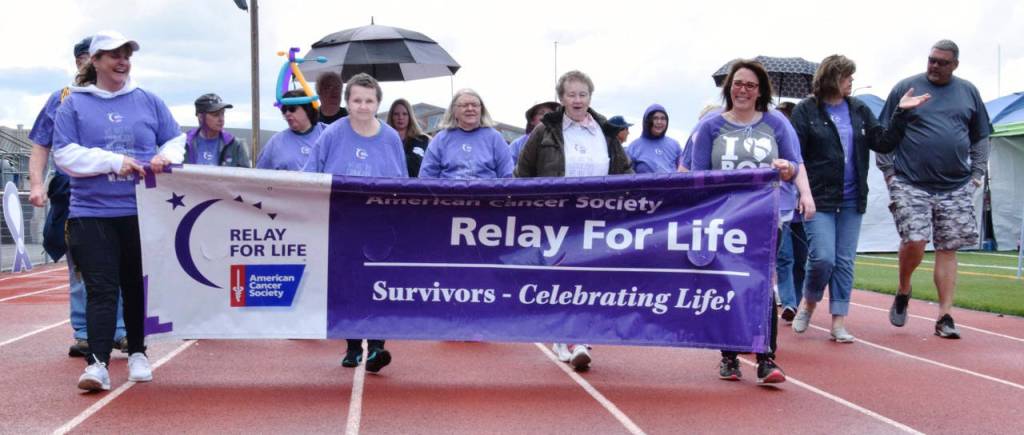 Cancer survivors walk with Crystal Tate and Marci Killian holding the sign. RACHEL CIAMPI, Reporter                                Cancer survivors walk. RACHEL CIAMPI, Reporter