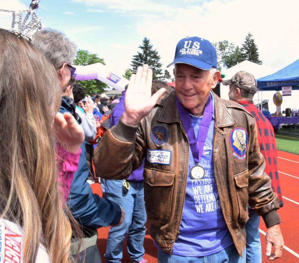 Cancer survivor and USAF Ret. Chester H. Wells Jr. gets a high five. RACHEL CIAMPI, Reporter