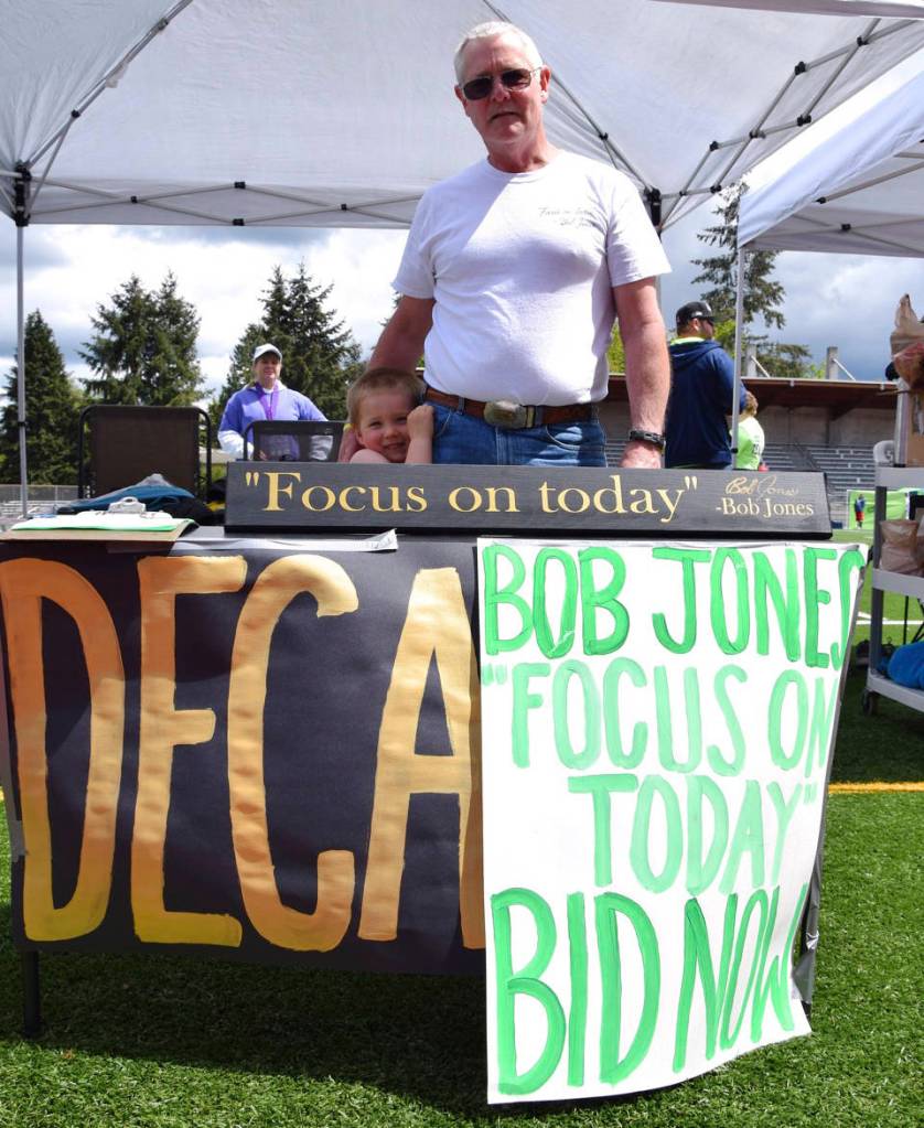 Bill Jones, the brother of the late Bob Jones, with his grandson Andrew Jones, 3. Bob Jones, longtime coach at athletic director at Auburn High School, lost his battle with cancer this year. RACHEL CIAMPI, Reporter