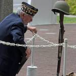 Tom Valencour, of American Legion Auburn Post 78, lights the Memorial Flame. MARK KLAAS, Auburn Reporter