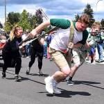 An Auburn High School group competes in a fire truck pull contest as the Valley Regional Fire Authority&rsquo;s Dave Larberg steers the vintage rig during the Relay for Life event at Auburn Memorial Stadium last Saturday. RACHEL CIAMPI, Auburn Reporter