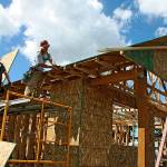 Volunteers continue to work on the nine-unit, veterans-focused community in Pacific last Saturday. Habitat for Humanity Seattle-King County and its partners are leading the effort. MARK KLAAS, Auburn Reporter