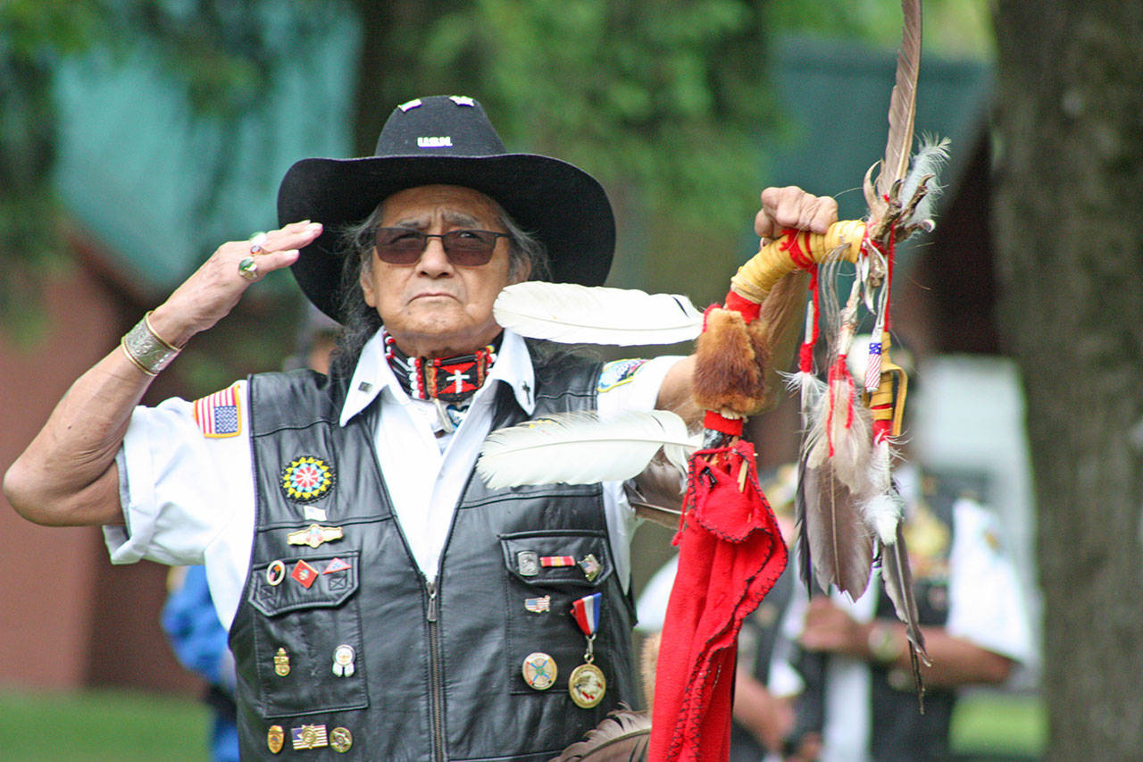 Bob Sison, veteran and chaplain of the Inter-Tribal Warrior Society, salutes during the Memorial Day ceremony at Auburn&rsquo;s Veterans Memorial Park on Monday. MARK KLAAS, Auburn Reporter