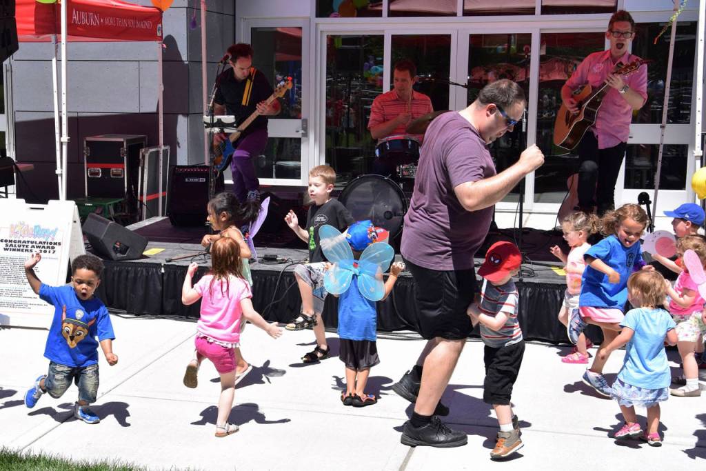 Recess Monkey performs on stage as kids dance. RACHEL CIAMPI, Auburn Reporter