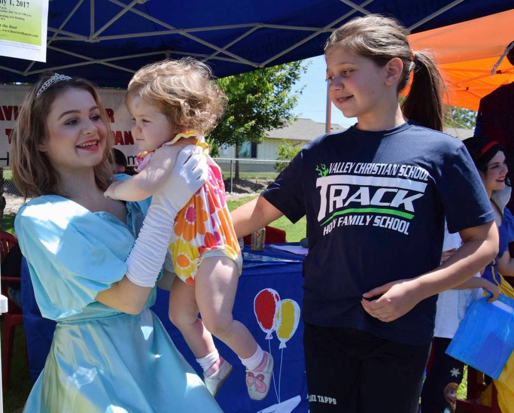 Sarah Jahns, 10, and her sister Charlotte, 1, visit Cinderella on KidsDay. Cinderella is their sister, Sophia. RACHEL CIAMPI, Auburn Reporter