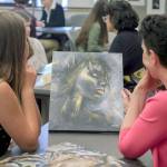 Monica Tolas, of Interurban Center for the Arts, right, studies the artwork of student Kristine Kravchishin during Green River College&rsquo;s recent Portfolio Review. COURTESY PHOTO, Jaclynn Board