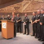 Kent Police spokeswoman Melanie Robinson on Monday at City Hall surrounded by representatives from law enforcement agencies across South King County. Mark Klaas/Kent Reporter