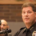 Kent Police Chief Ken Thomas shows a gun at a Monday news conference at City Hall confiscated during a March crime. Mark Klaas/Kent Reporter