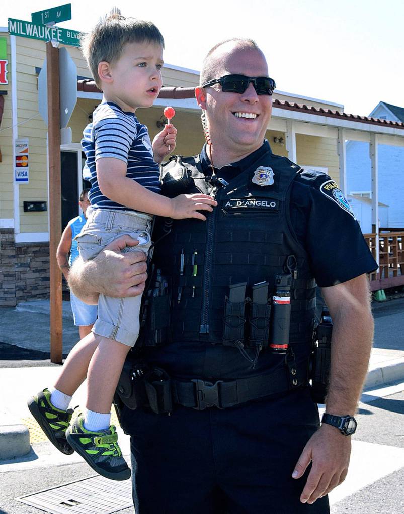Algona Police Officer Anthony D&rsquo;Angelo and his son, Nolan, 3, take in the parade. RACHEL CIAMPI, Auburn Reporter