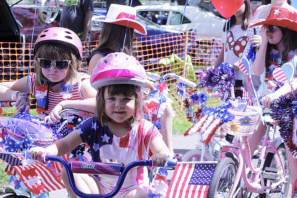 Teagan, left, and Taylor Bartos, middle, lead the way for the Kids&rsquo; Bike Parade. MARK KLAAS, Auburn Reporter